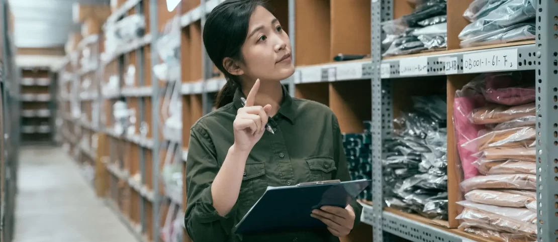 Woman picking apparel item from pick and pack area